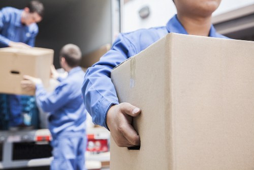 Removal Company Brixton introduction with moving team and packed boxes