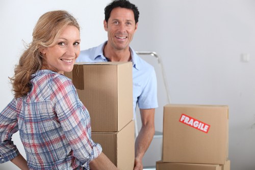 Furniture removal team navigating stairs in a Brixton apartment building